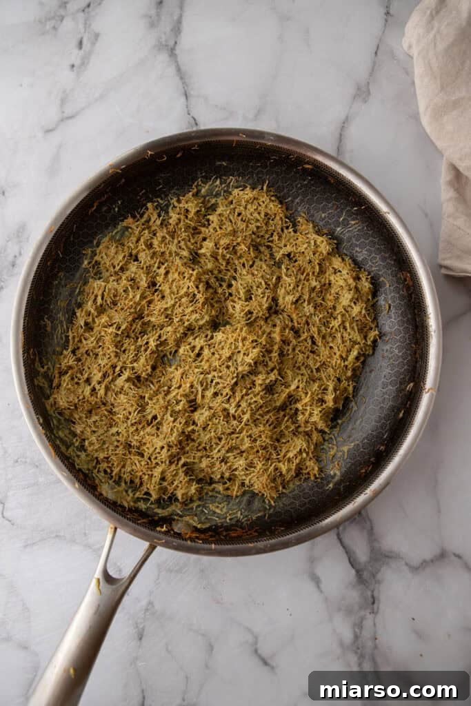 Dubai's Viral Pistachio Kunafa Brownies 16 mixed ingredients in a pan, showing pistachio kataifi mixture