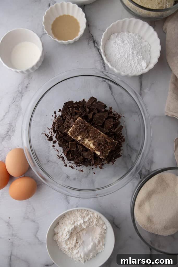 Dubai's Viral Pistachio Kunafa Brownies 6 ingredients in a bowl, showing melted chocolate mixture