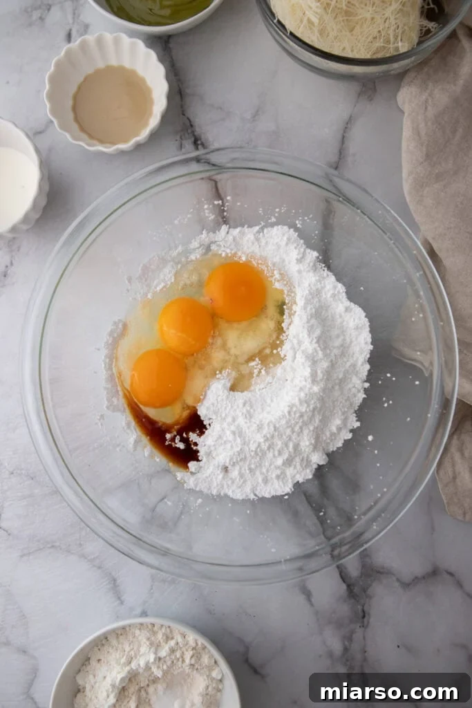 Dubai's Viral Pistachio Kunafa Brownies 9 ingredients in a bowl, showing egg and sugar mixture