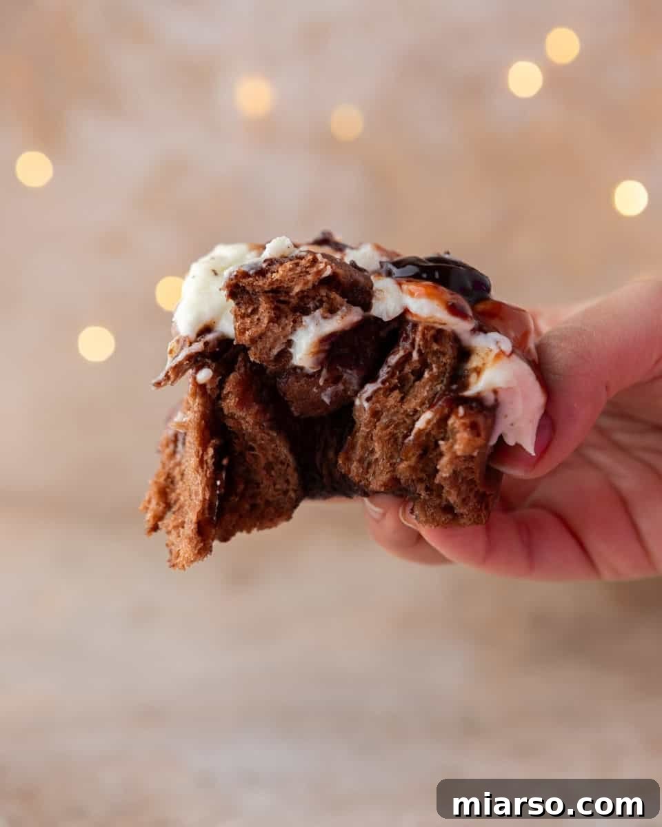 Hand holding broken in half chocolate roll