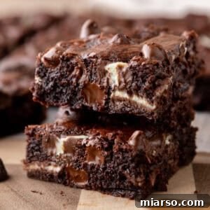 Ultra Fudgy Crinkled Andes Mint Brownies 11 Andes mint brownies stacked to show fudgy centers with melted chocolate chunks