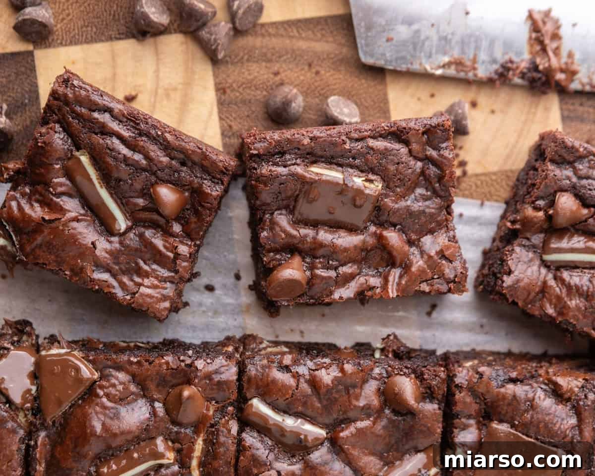Ultra Fudgy Crinkled Andes Mint Brownies 10 Freshly baked Andes Mint brownies cut into perfect squares, showcasing their shiny, crackly tops and rich color.