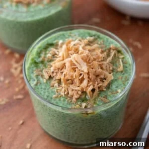 Matcha chia pudding topped with toasted coconut in a glass bowl, showcasing its vibrant color and tempting texture.