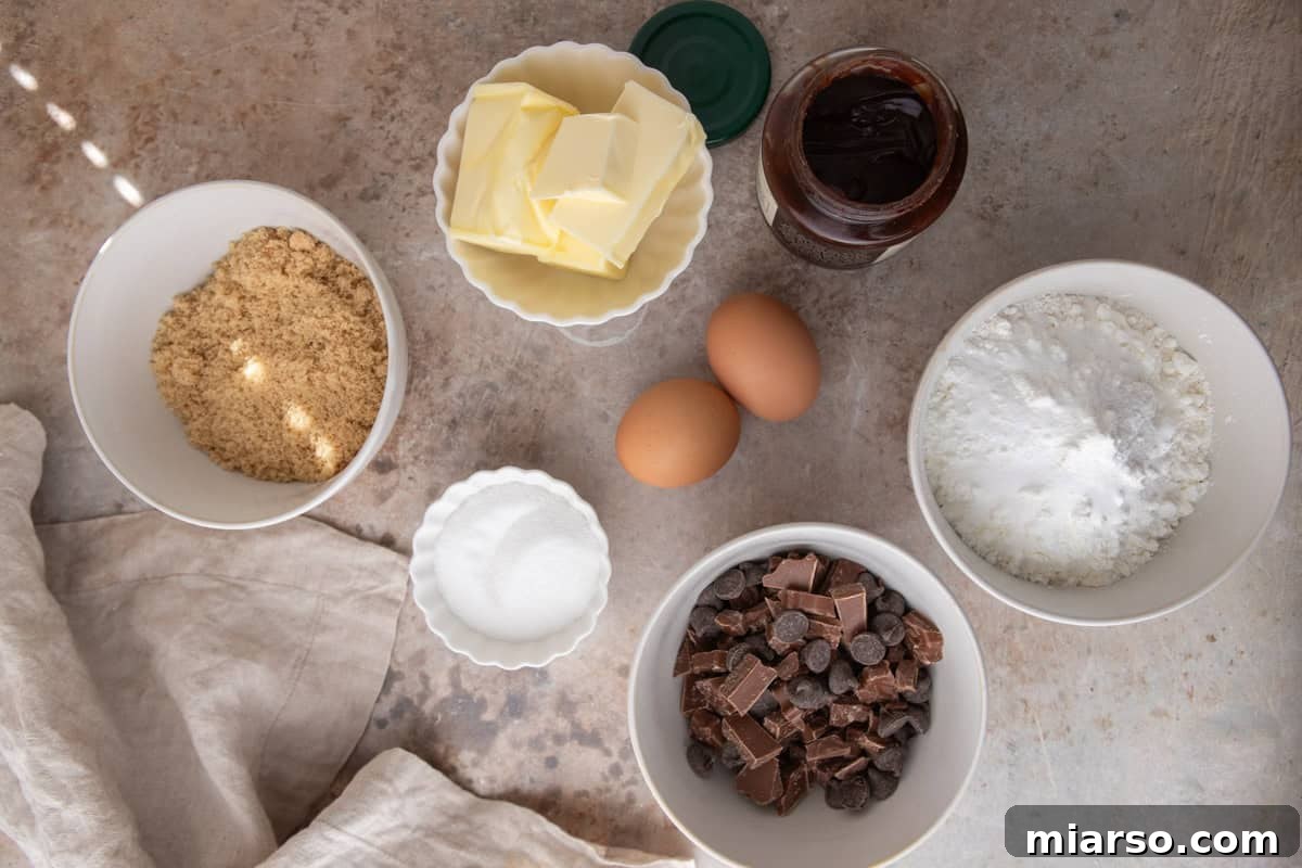 Ingredients for brown butter chocolate chip cookies including flour, butter, eggs, sugar, and chocolate