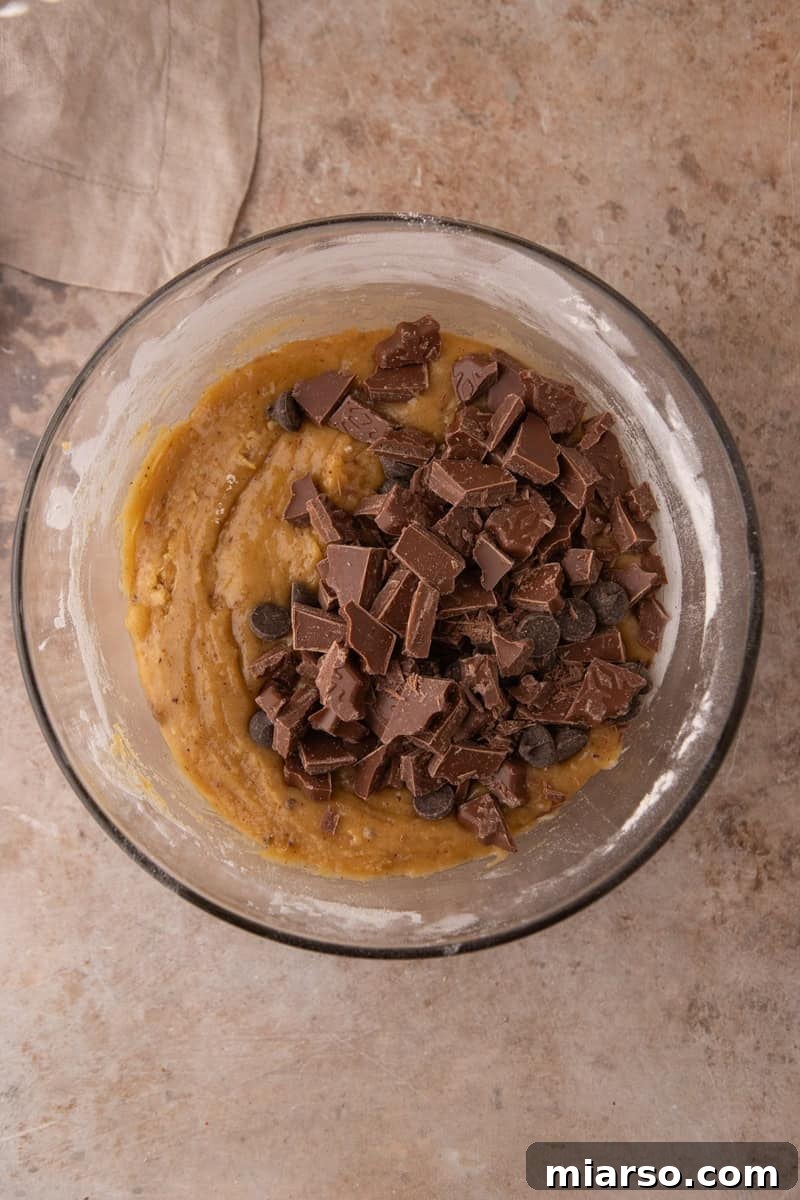 Chocolate chips and chopped chocolate folded into cookie dough