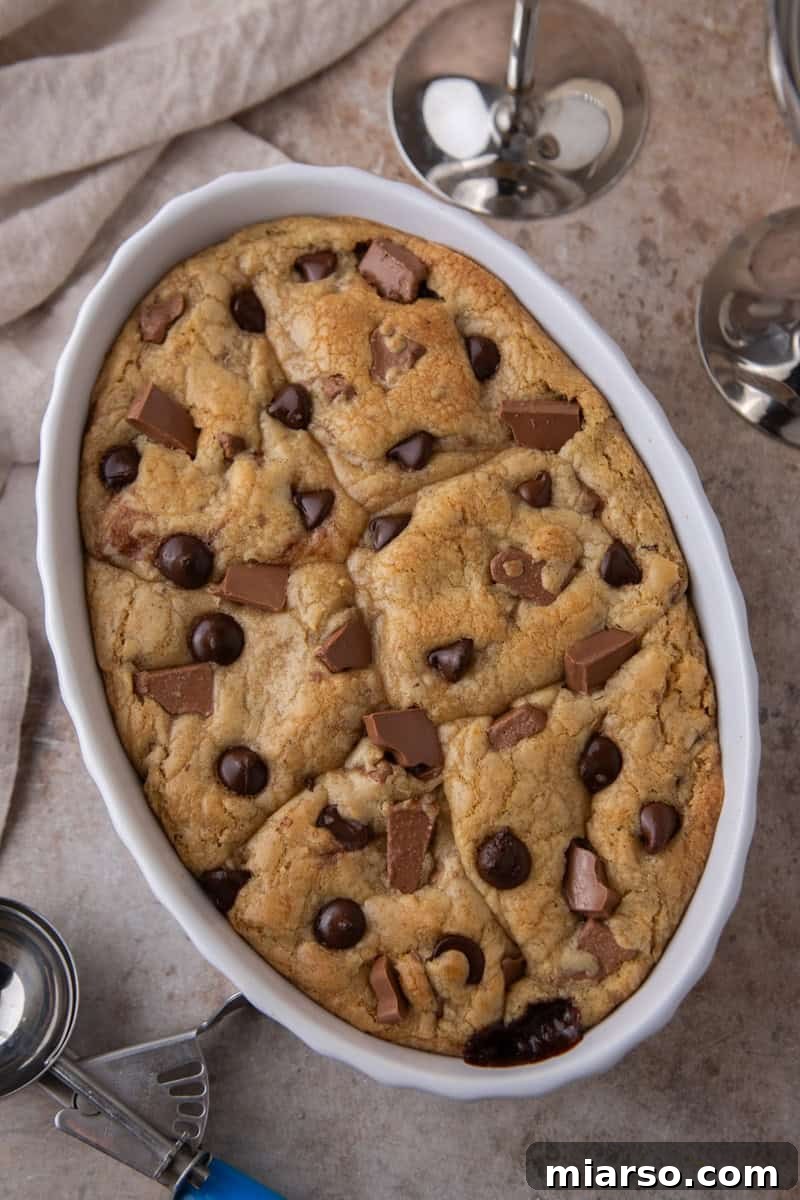 Golden brown chocolate chip cookies baked together in a ceramic baking dish