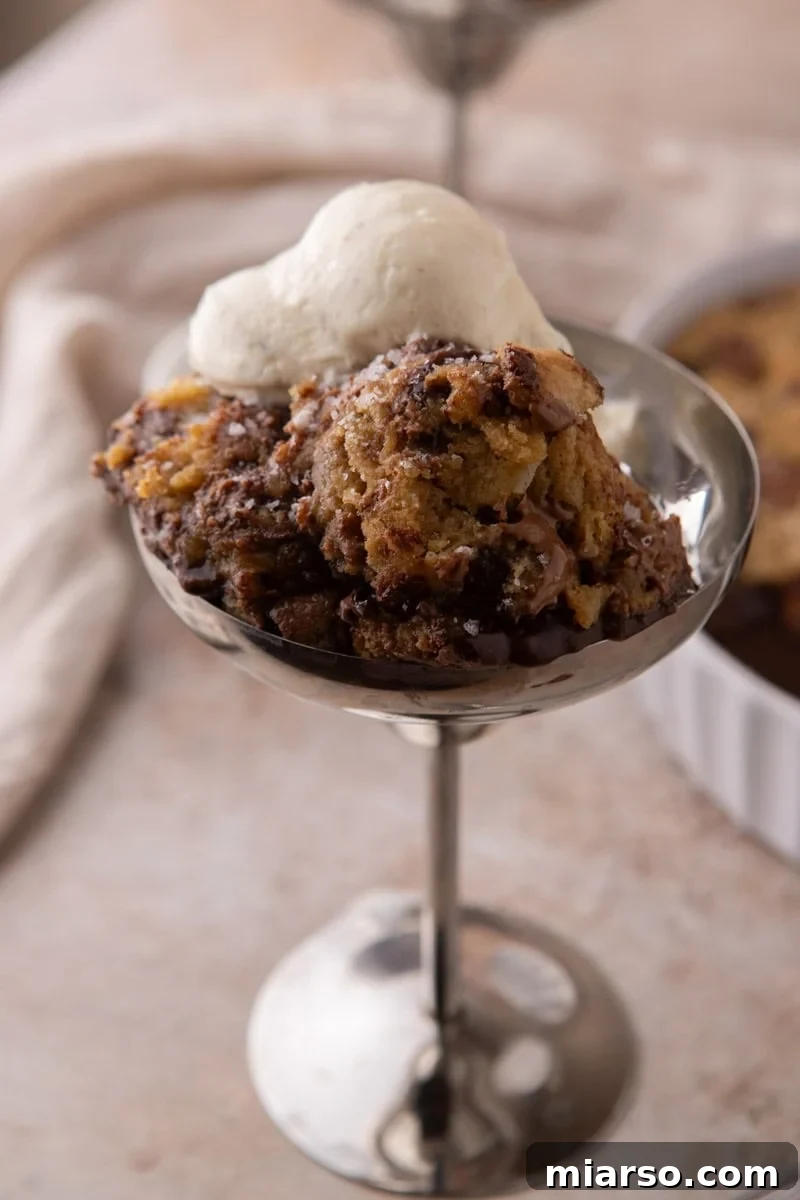 Warm scoopable chocolate chip cookie served with vanilla ice cream