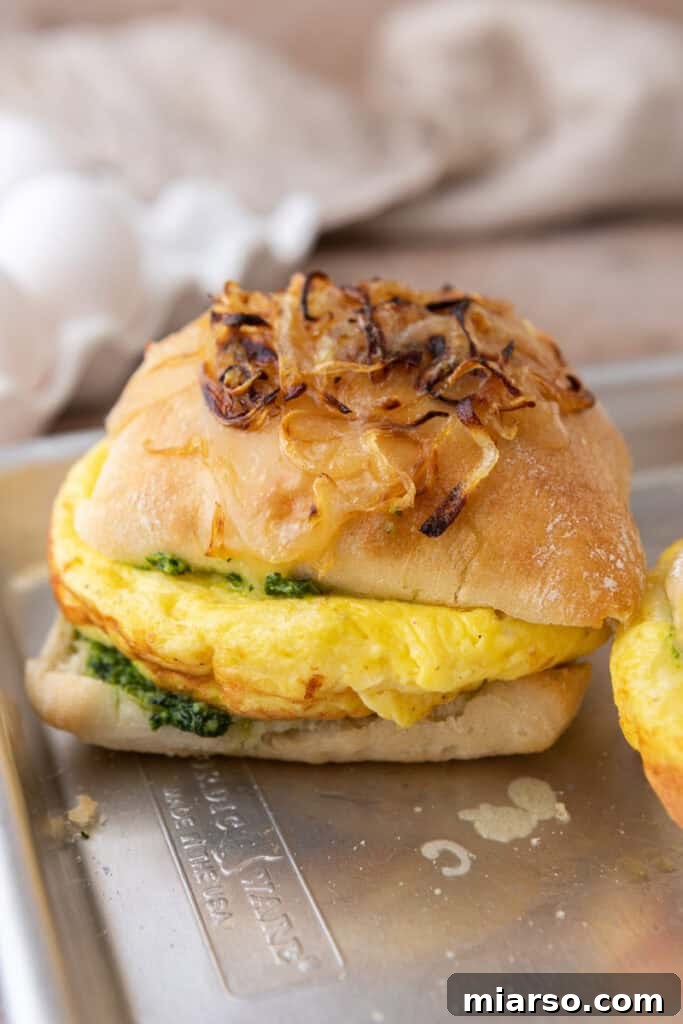 Homemade Starbucks egg kale pesto mozzarella breakfast sandwich on a cheesy onion bun