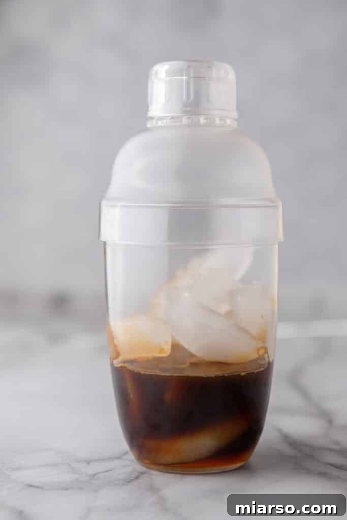 Espresso and ice in a cocktail shaker before making a homemade Starbucks shaken espresso