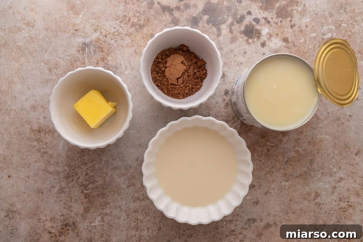 Chocolate glaze ingredients including butter, cocoa powder, evaporated milk, and an open can of sweetened condensed milk