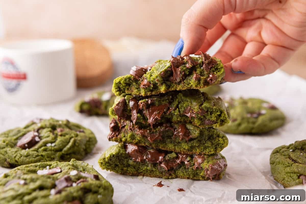 Velvet Matcha Chocolate Chip Cookies 2 Stack of broken matcha chocolate chip cookies showing the soft chewy center and gooey melted chocolate