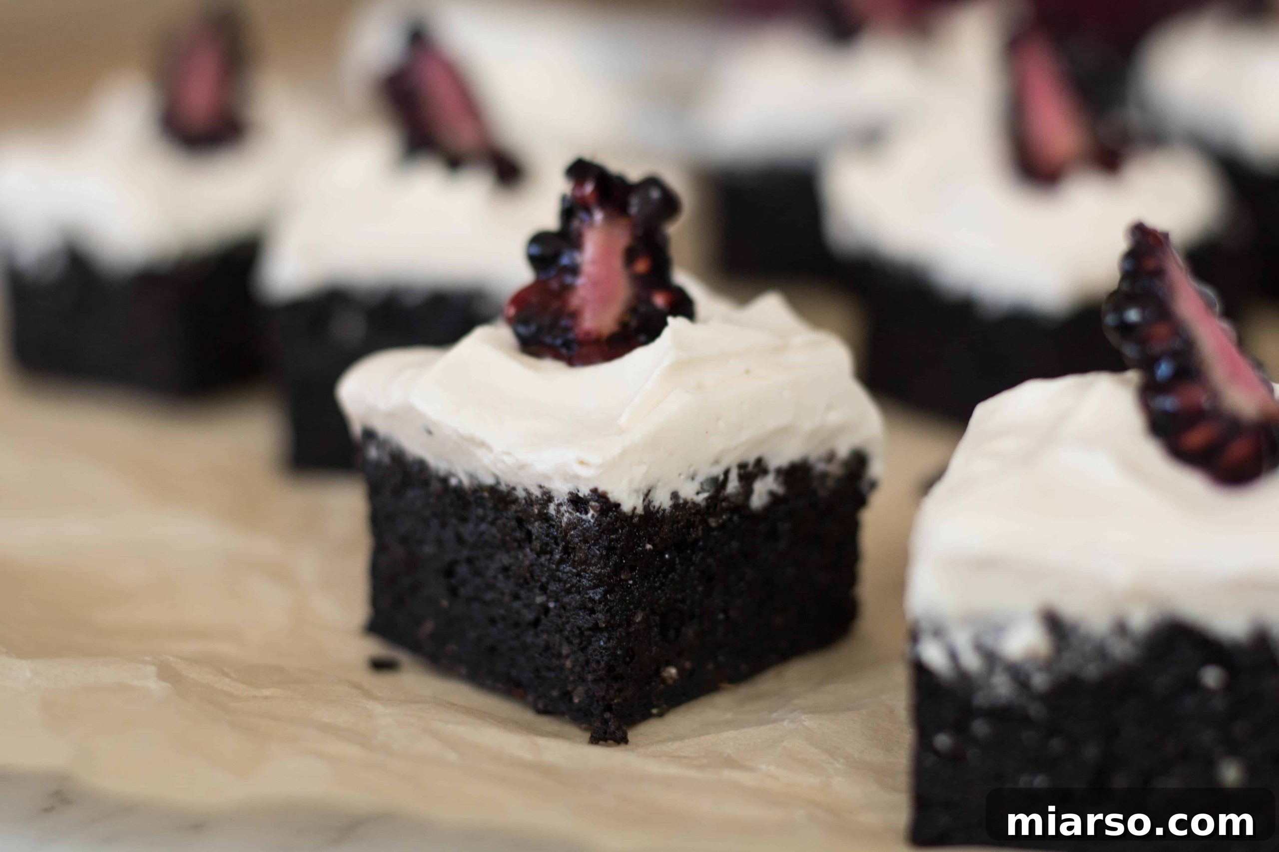 Overhead view of a rich chocolate brownie pudding or sweet potato brownie, beautifully baked in a round metal pan on a rustic wooden cutting board, accompanied by spoons and delicate chocolate shavings.