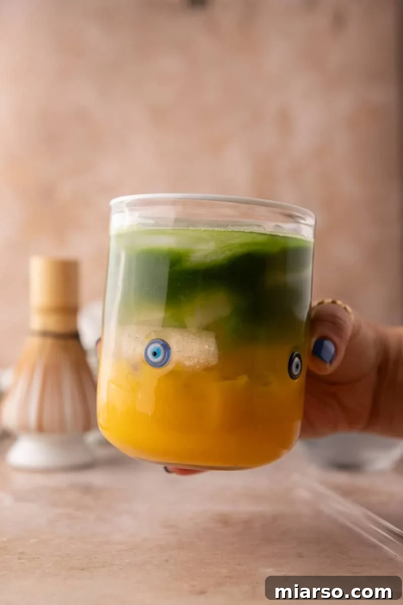 layered mango matcha drink with coconut water, showing a beautiful marble effect