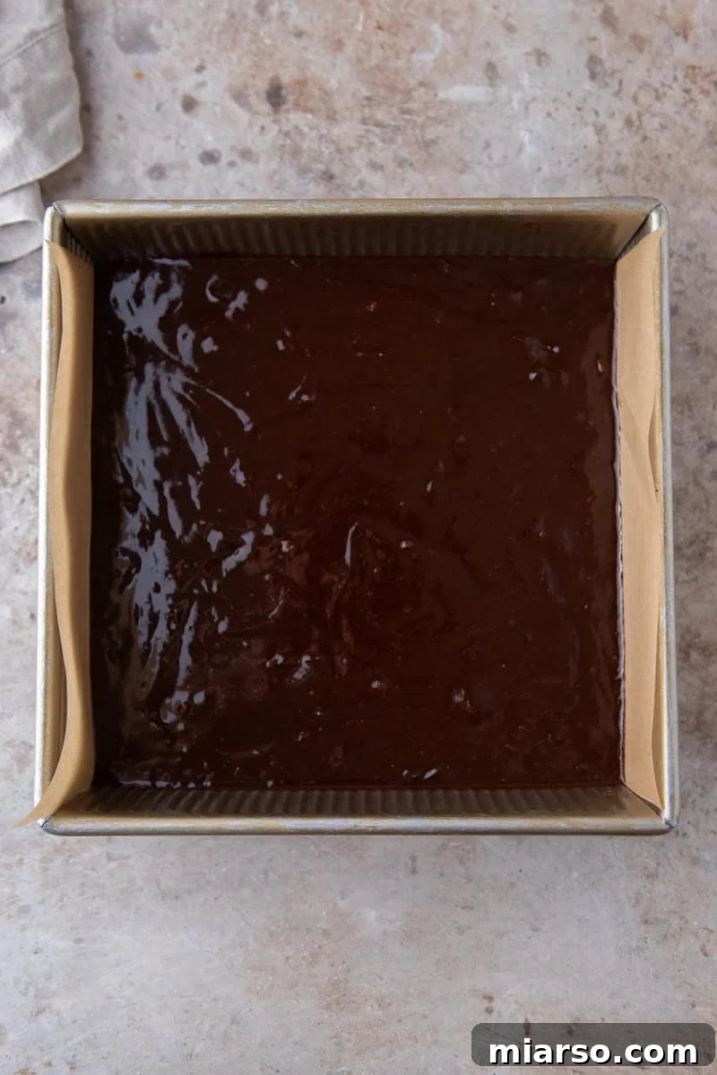 Espresso Fudge Brownies 11 Espresso brownie batter poured into a parchment lined 8x8 metal baking pan