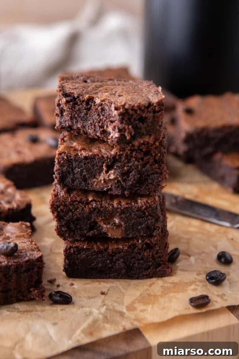Espresso Fudge Brownies 3 Stack of three chocolate coffee brownies showing dense fudgy centers
