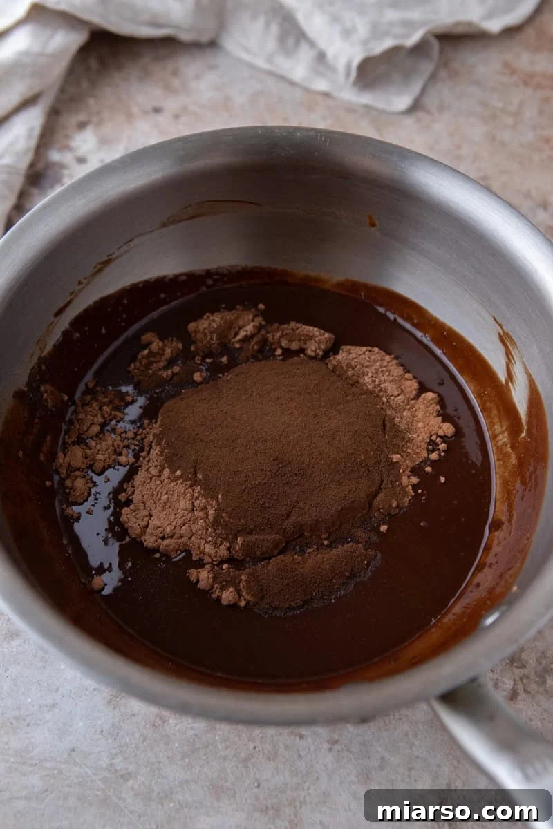 Espresso Fudge Brownies 6 Melted chocolate mixture with cocoa powder and espresso powder added in a saucepan