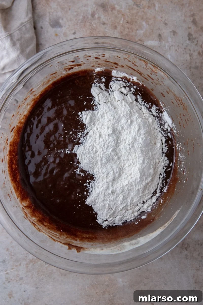 Espresso Fudge Brownies 9 Brownie batter with flour and cornstarch sifted on top before folding