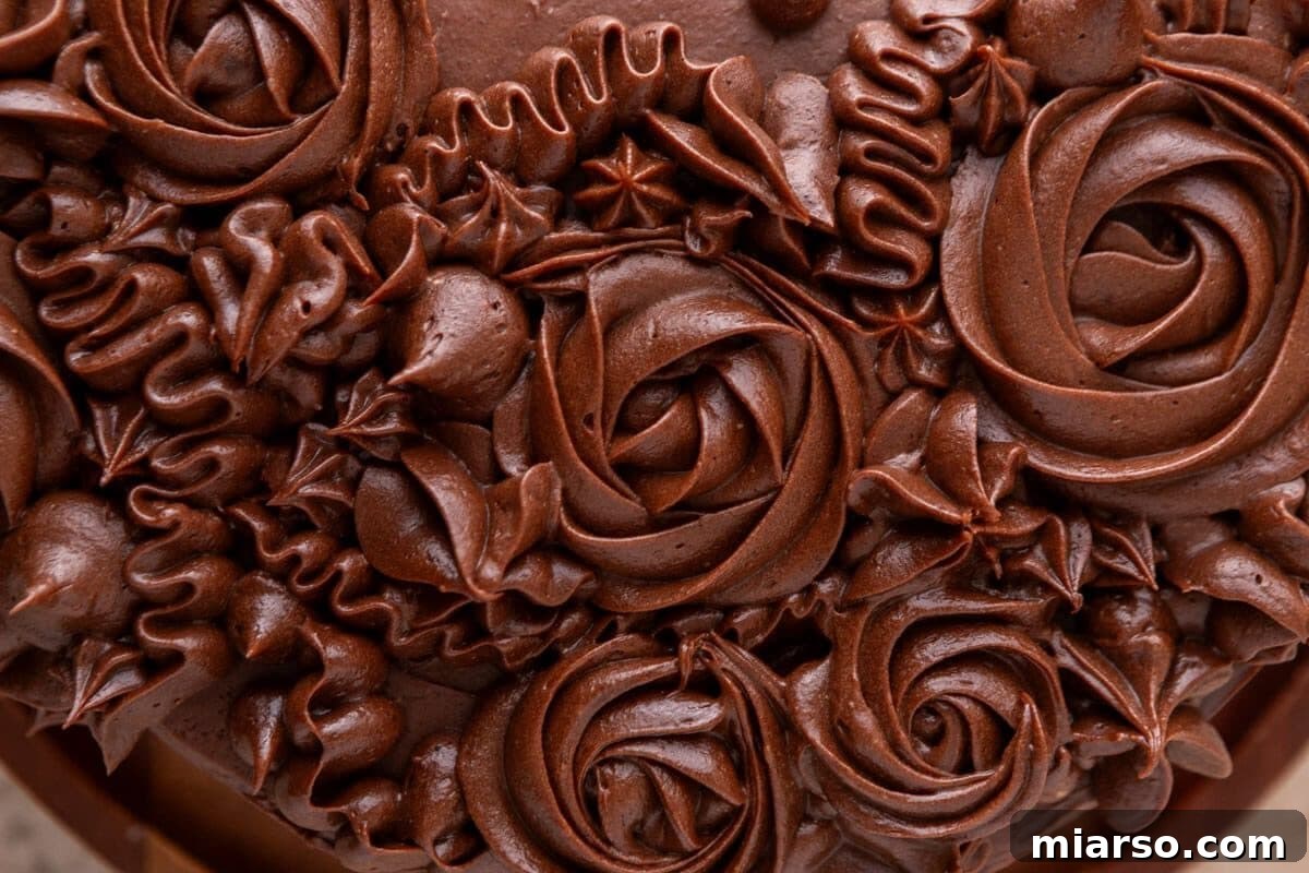 Ultimate Moist Marble Layer Cake with Rich Chocolate Cream Cheese Frosting 15 Close-up of smooth, silky chocolate cream cheese frosting showing the creamy, fudgy texture