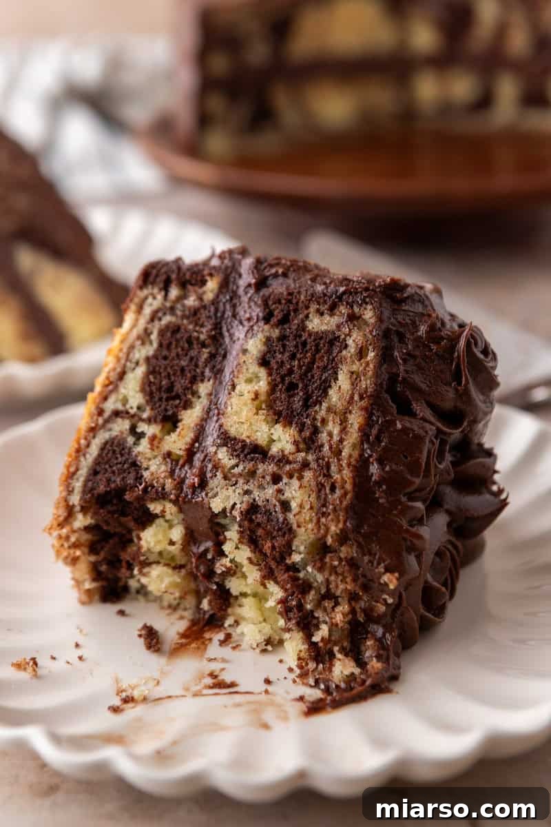 Ultimate Moist Marble Layer Cake with Rich Chocolate Cream Cheese Frosting 4 Close-up of a marble cake slice showing the moist crumb and bold chocolate and vanilla swirl pattern