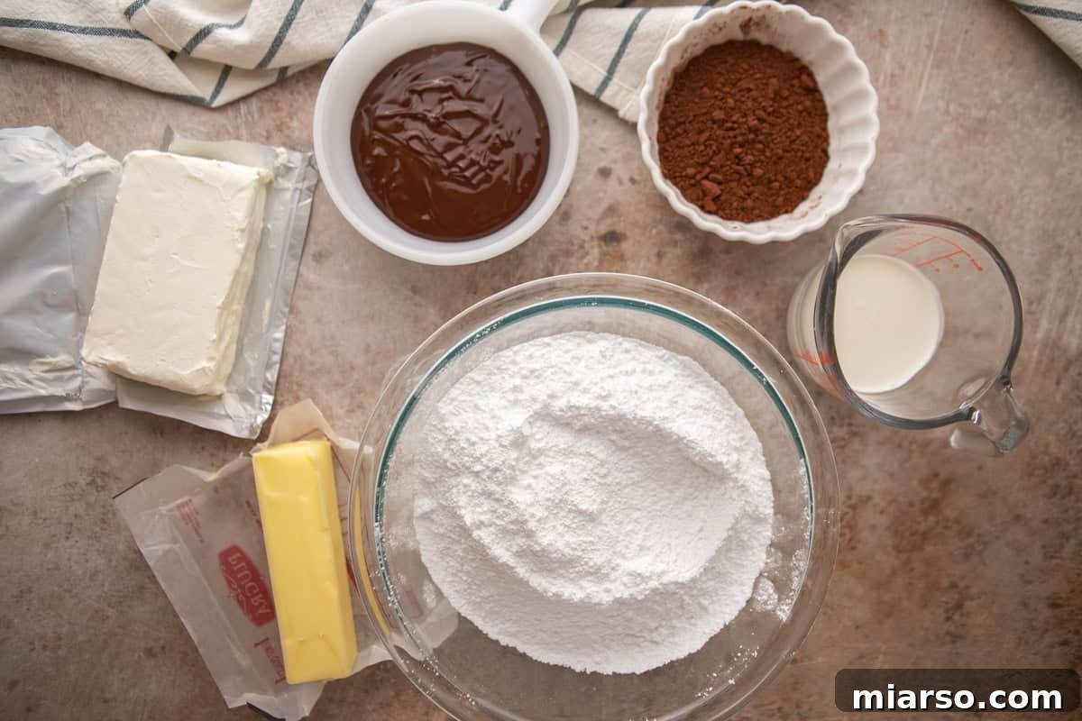 Velvety Chocolate Cream Cheese Indulgence 3 Ingredients for chocolate cream cheese frosting including cream cheese, butter, powdered sugar, cocoa powder, melted chocolate, and heavy cream