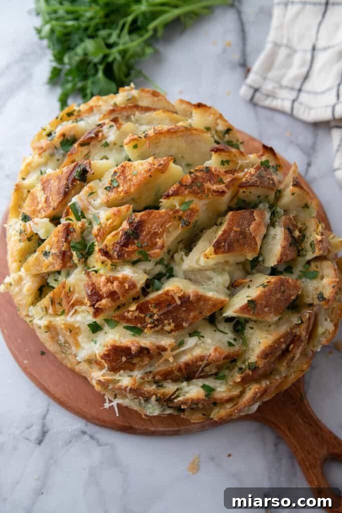 Golden baked garlic cheese bread served on wooden board
