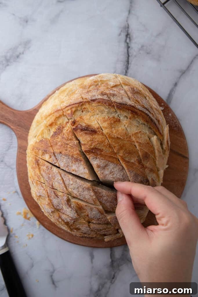 Sourdough loaf cut in crosshatch pattern before stuffing it
