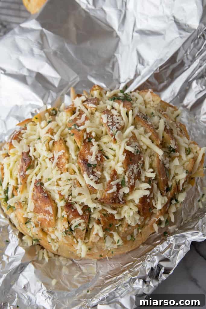 Unbaked sourdough garlic bread topped with shredded mozzarella and parmesan
