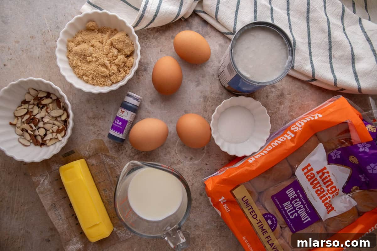 Ingredients for ube French toast bake including King's Hawaiian Ube Coconut rolls, eggs, coconut milk, brown sugar, butter, ube extract, and sliced almonds