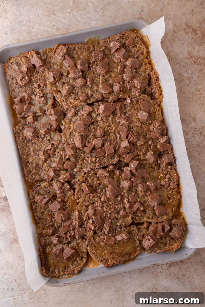 Tony's Chocolonely chunks scattered over hot caramel coated banana bread, just out of the oven.