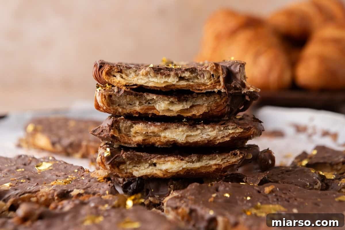 Stack of croissant Christmas crack pieces showing flaky layered croissant, brown sugar toffee, and chocolate top
