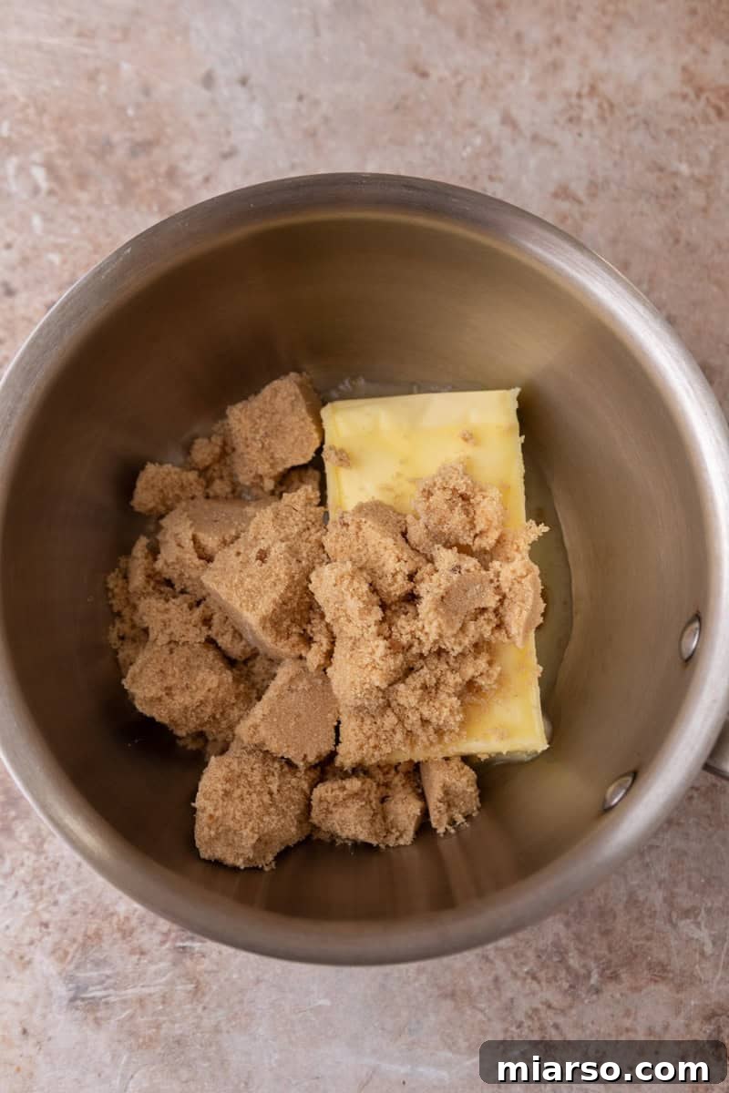 Unsalted butter and light brown sugar in a saucepan before making toffee for croissant crack