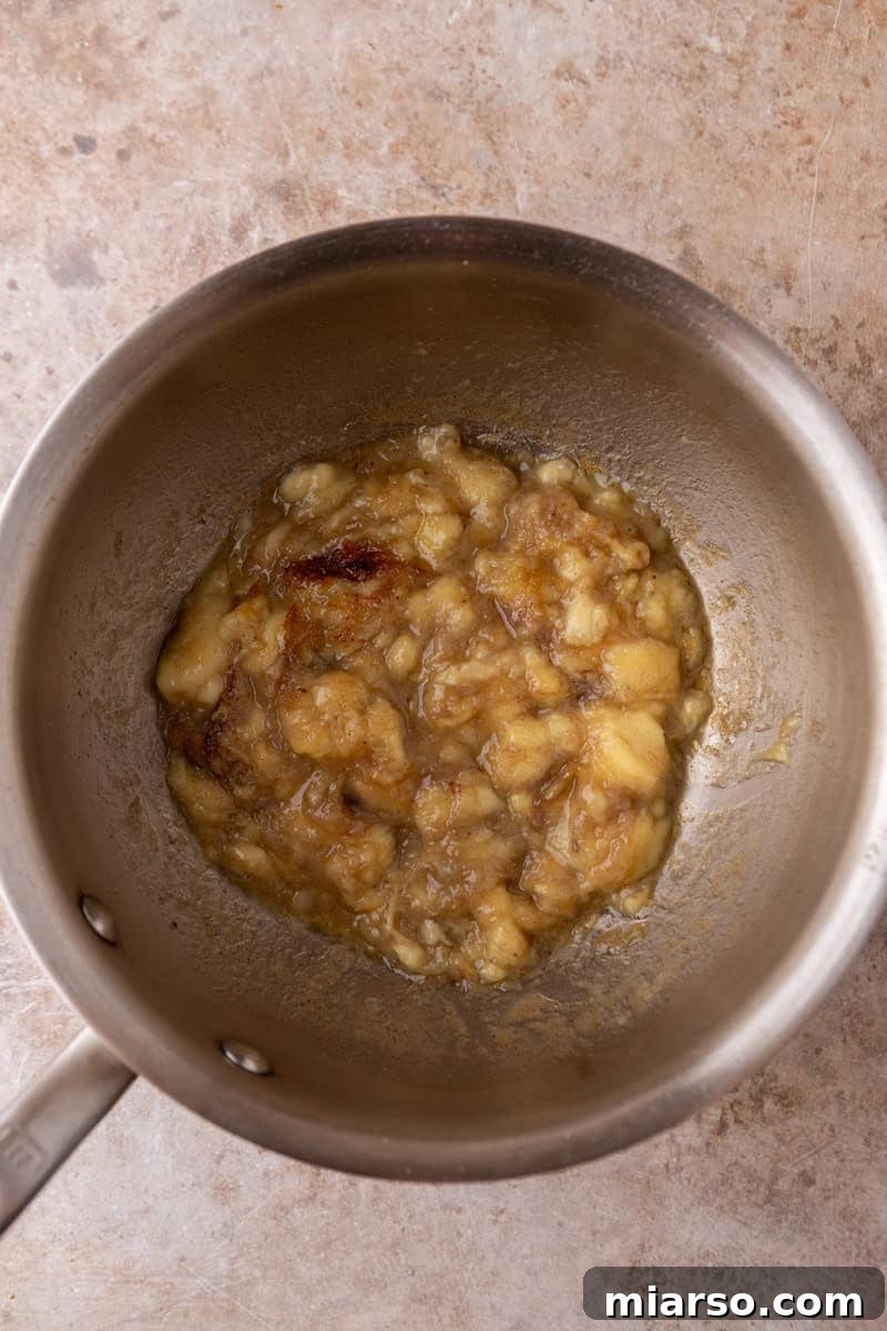 Mashed bananas caramelizing in brown butter in a saucepan