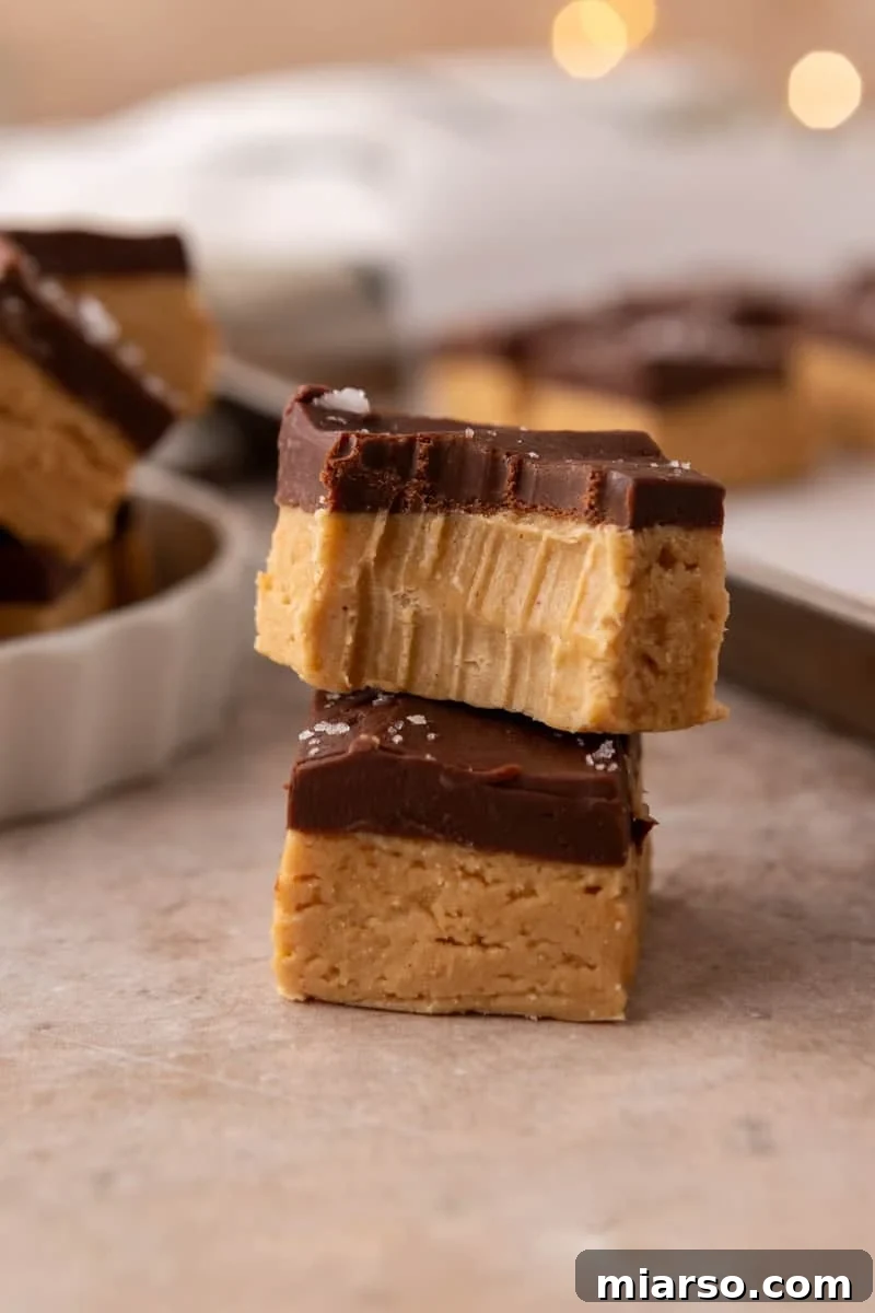 Close up of buckeye fudge showing the peanut butter layer and chocolate top with a bite taken