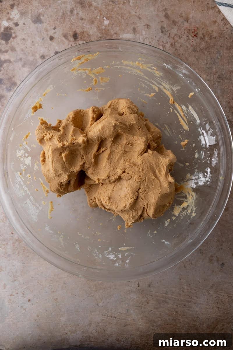 Thick peanut butter fudge dough formed into a ball in a glass bowl