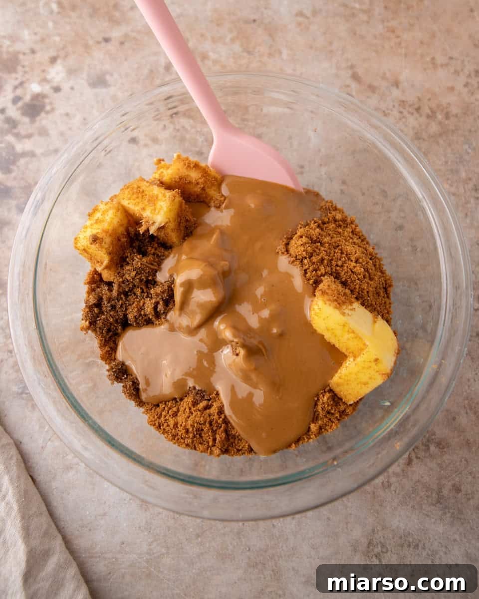 Cookie butter, brown sugar and butter in a glass bowl before mixing the cinnamon roll filling