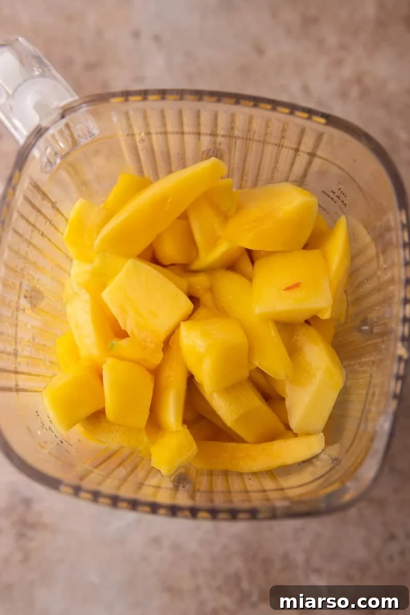  Fresh mango chunks in a blender before blending smoothly