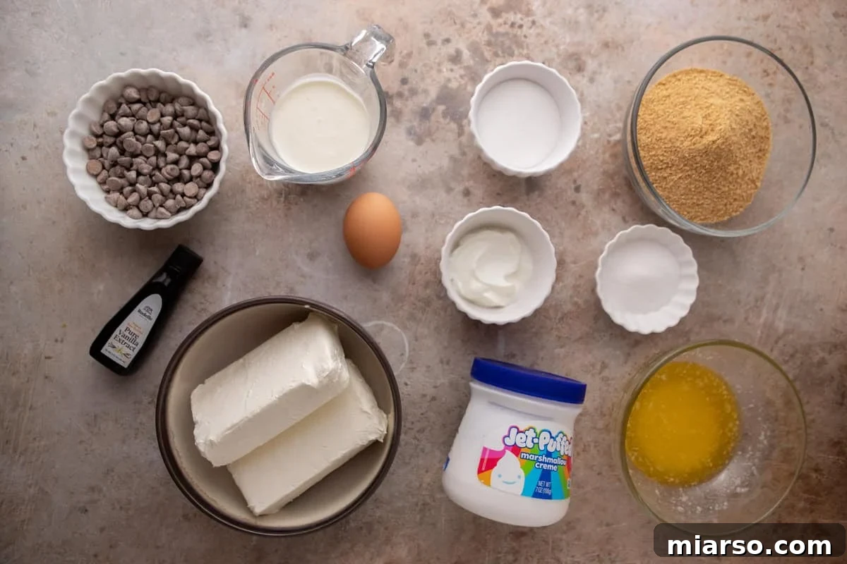 Ingredients including cream cheese, marshmallow fluff, graham crumbs, chocolate, sugar, sour cream, butter, and an egg