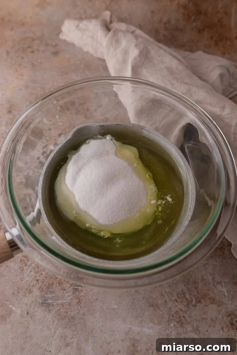 Egg whites and sugar in a glass bowl to make Swiss meringue