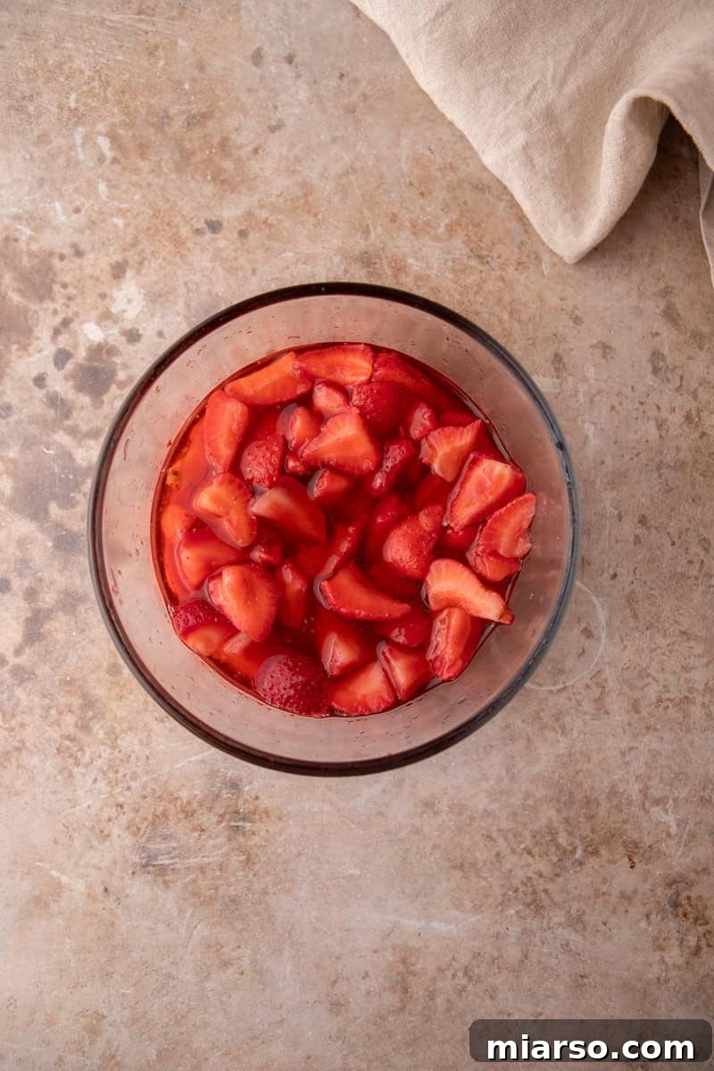 Mini Strawberry Shortcake Trifle Cups Recipe 8 Macerated strawberries sitting in their own ruby red syrup in a glass bowl.