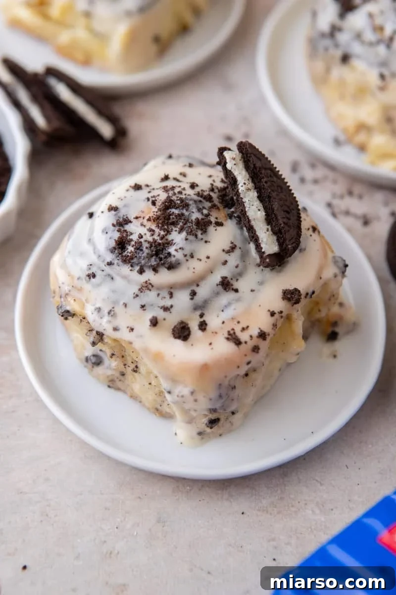 Oreo-Stuffed Cinnamon Rolls with Cream Cheese Glaze 2 Oreo cinnamon roll topped with cream cheese glaze, crushed Oreos, and a half Oreo cookie
