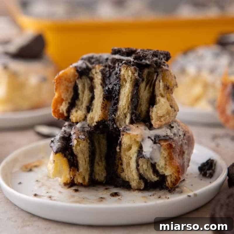 Oreo-Stuffed Cinnamon Rolls with Cream Cheese Glaze 14 Cross section of Oreo cinnamon rolls stacked showing the filling layers and glaze